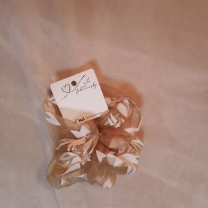 Gold and white hair tie.